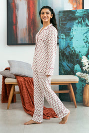 Featuring a soft button-down shirt and relaxed-fit pajama bottoms, the Coral Blush Cozy Button Down Shirt for Women is perfect for lounging.