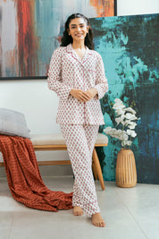 The Coral Blush Women's Button Down Pajama Set offers a soft and breathable feel, perfect for a cozy night’s sleep.