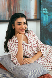 The Coral Blush Women's Button Down Shirt Pajama Set offers a timeless look with a relaxed silhouette for bedtime or lounging.