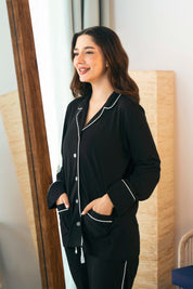 The Midnight Star Women's Button Down PJ Set features a classic button-up top with comfy pajama bottoms.