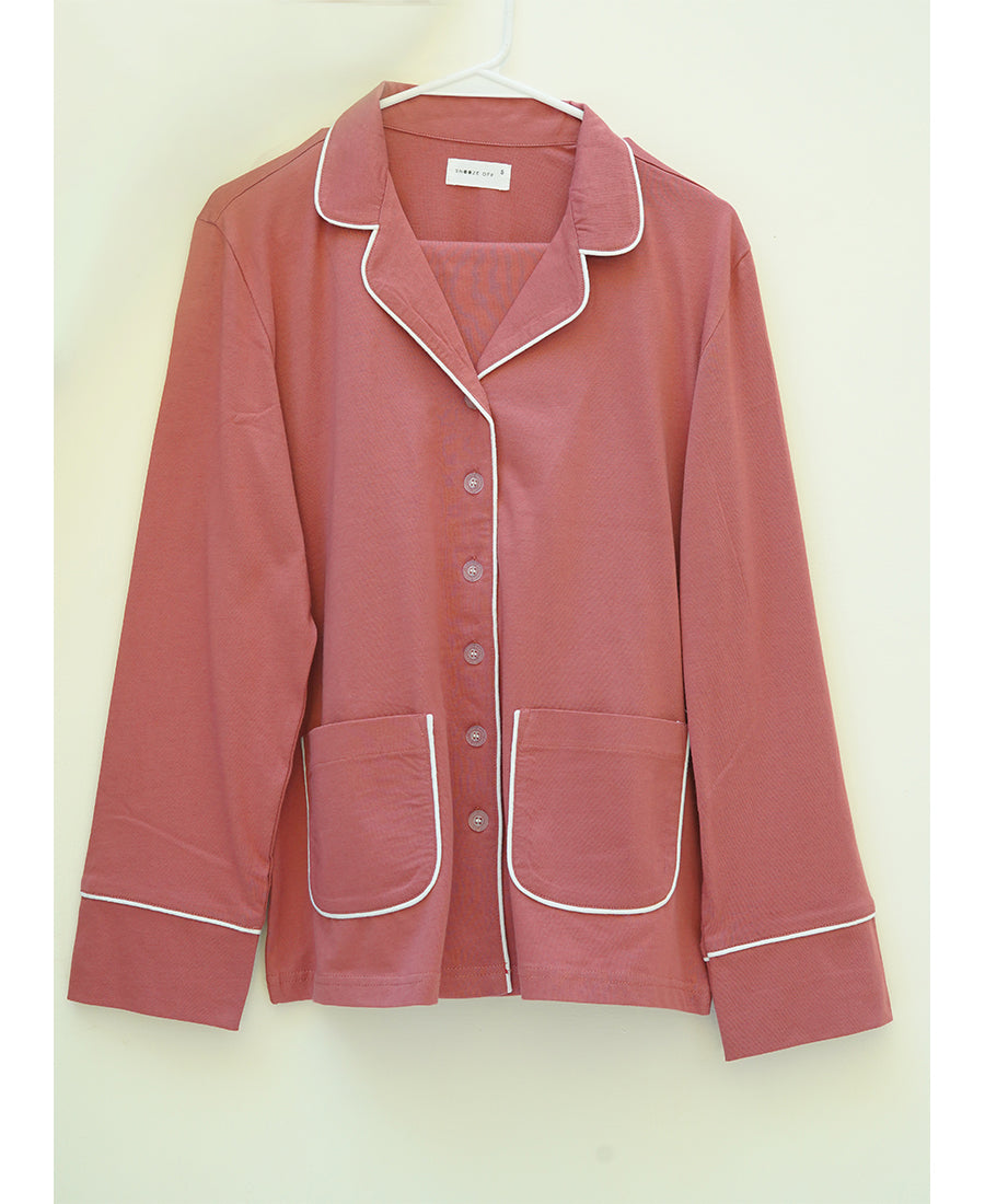 Relax in the Sunset Pink Button Down Pajamas for Women, designed for breathable comfort all night long.