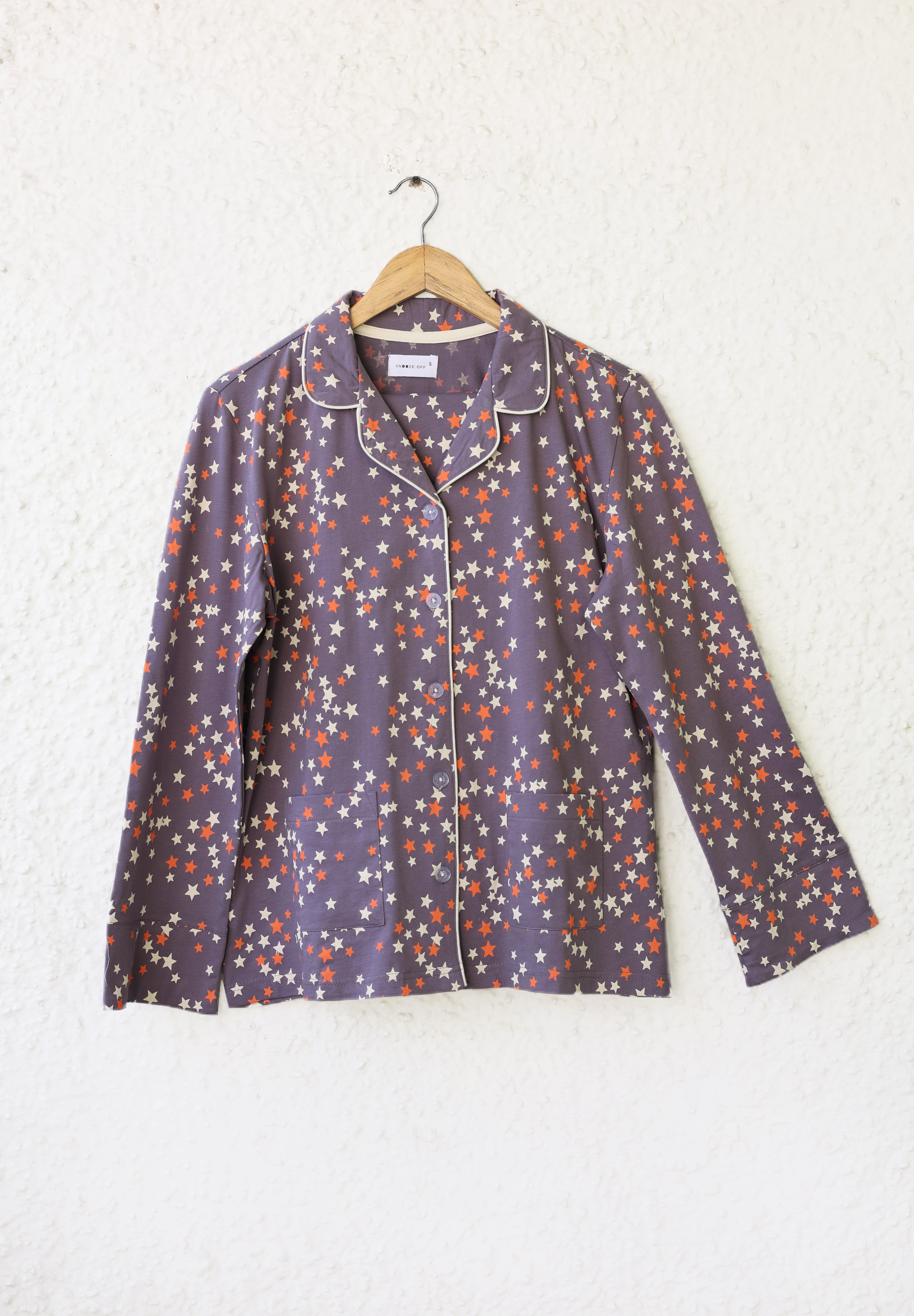 The Under the Stars Women's Button Down Pajama Set in dusky purple offers a cozy and breathable fit for a peaceful night's sleep.